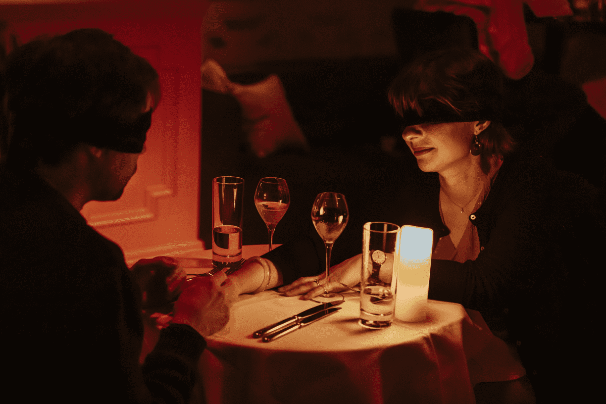 A couple enjoying a Dining in the Dark experience