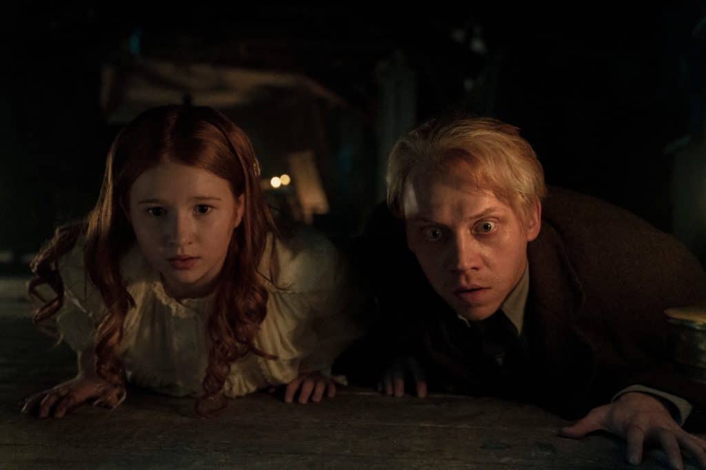 Guillermo del Toro's Cabinet Of Curiosities. (L to R) Daphne Hoskins as Epperley, Rupert Grint as Walter Gilman in episode “Dreams In The Witch House” of Guillermo del Toro's Cabinet Of Curiosities-comes-to-netflix-october-2022.