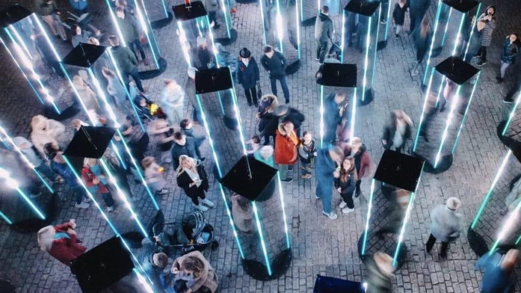 People standing between mirrored monoliths at Bristol Light Festival