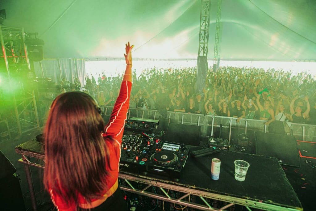 a dj in front of the crowd in a tent at the Live At Lydiard festival in 2021
