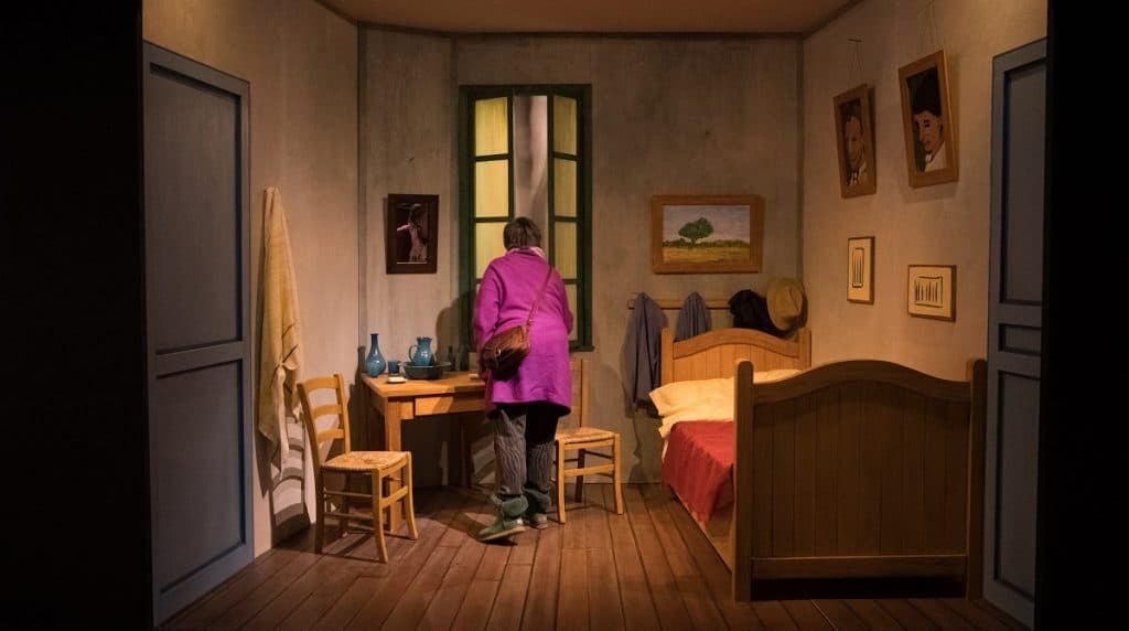 A woman explores a recreation of Van Gogh's Bedroom in Arles.