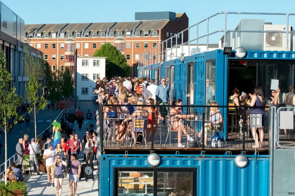 wapping-wharf-shipping-containers-people-sat-on-balcony