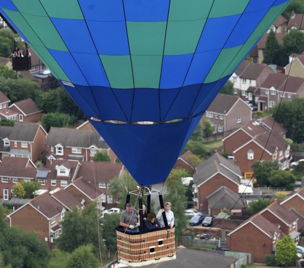 A hot air-balloon over Bristol houses