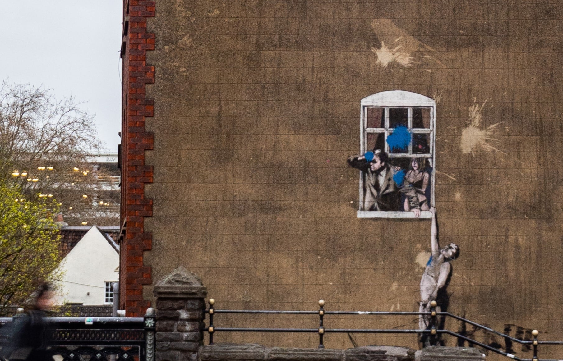 View from across the street of one of Banksy's artwork, Well Hung Lover.