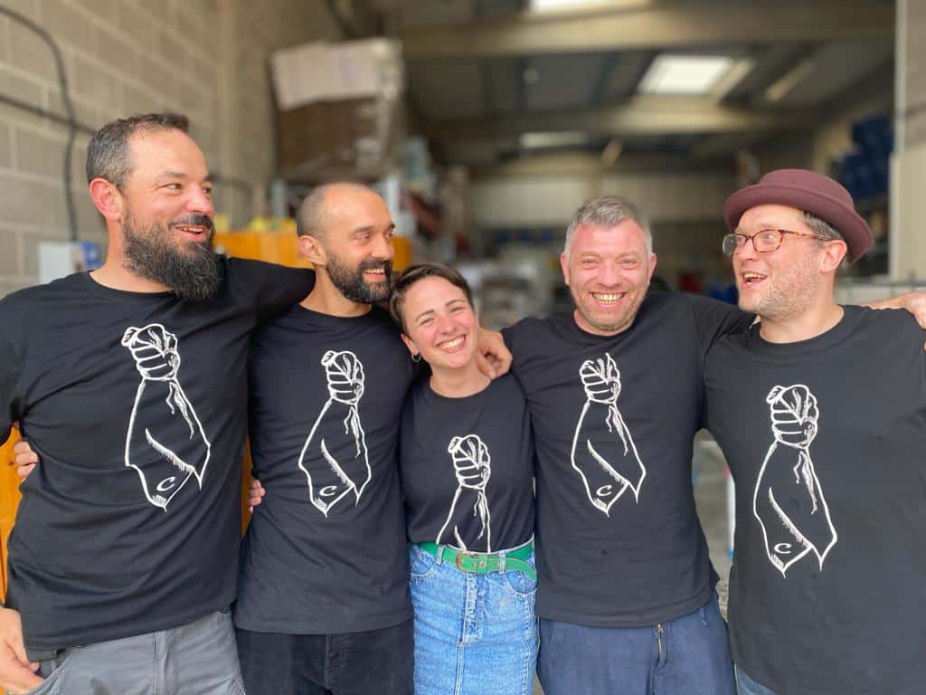 Five members of Circumstance Distillery with arms wrapped around each other smiling