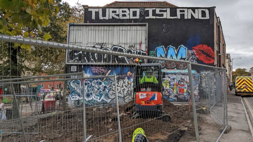 Turbo Island surrounded by a fence with a digger digging up the ground