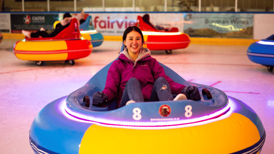A woman smiling in an ice bumper car at Winterland