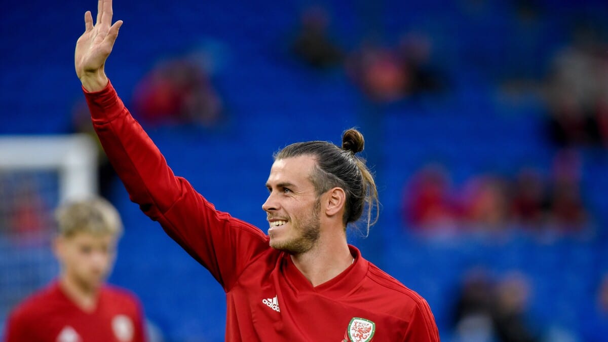 Gareth Bale waving at fans in a Wales kit