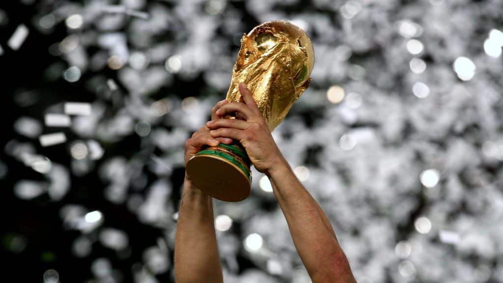 2022 FIFA World Cup trophy being lifted up high