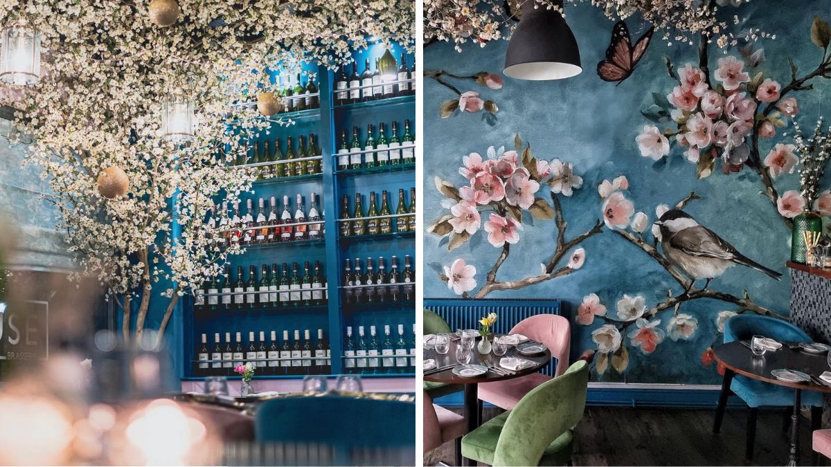 Muse brasserie restaurant with a blossom tree wallpaper and shelves of wines
