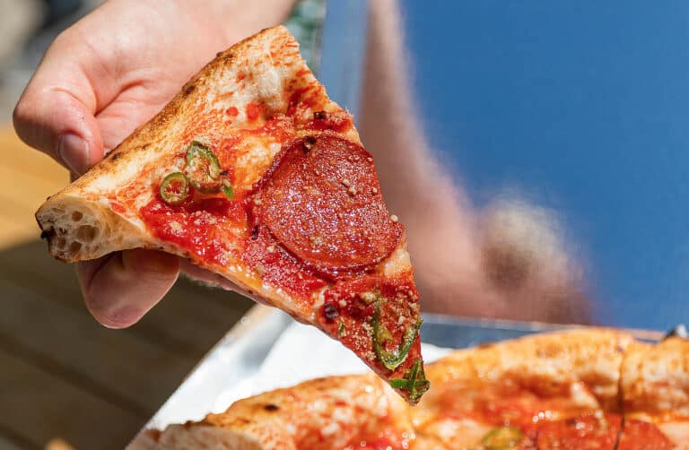Slice of vegan pizza from purezza