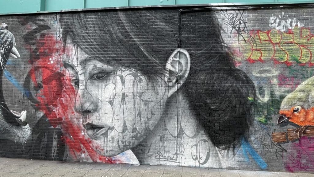 Street Art Cities nominee graffiti mural in Bristol by Swalt. Featuring a woman's face in grey tones