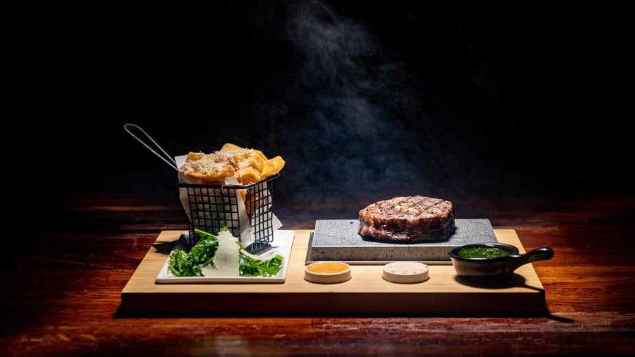 A wooden board with steak and chips from Mugshot, one of the most romantic restaurants in Bristol