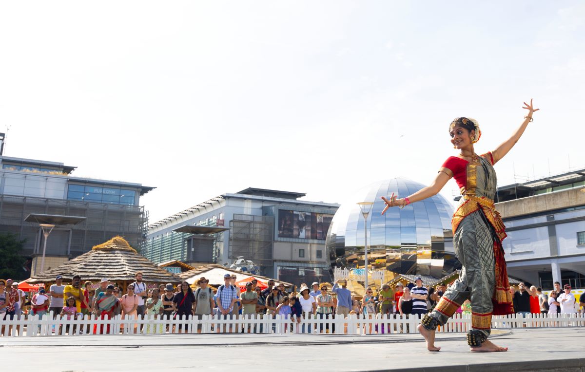 A dancer performing on Millennium promenade to a crowd at Bristol Harbour Festival