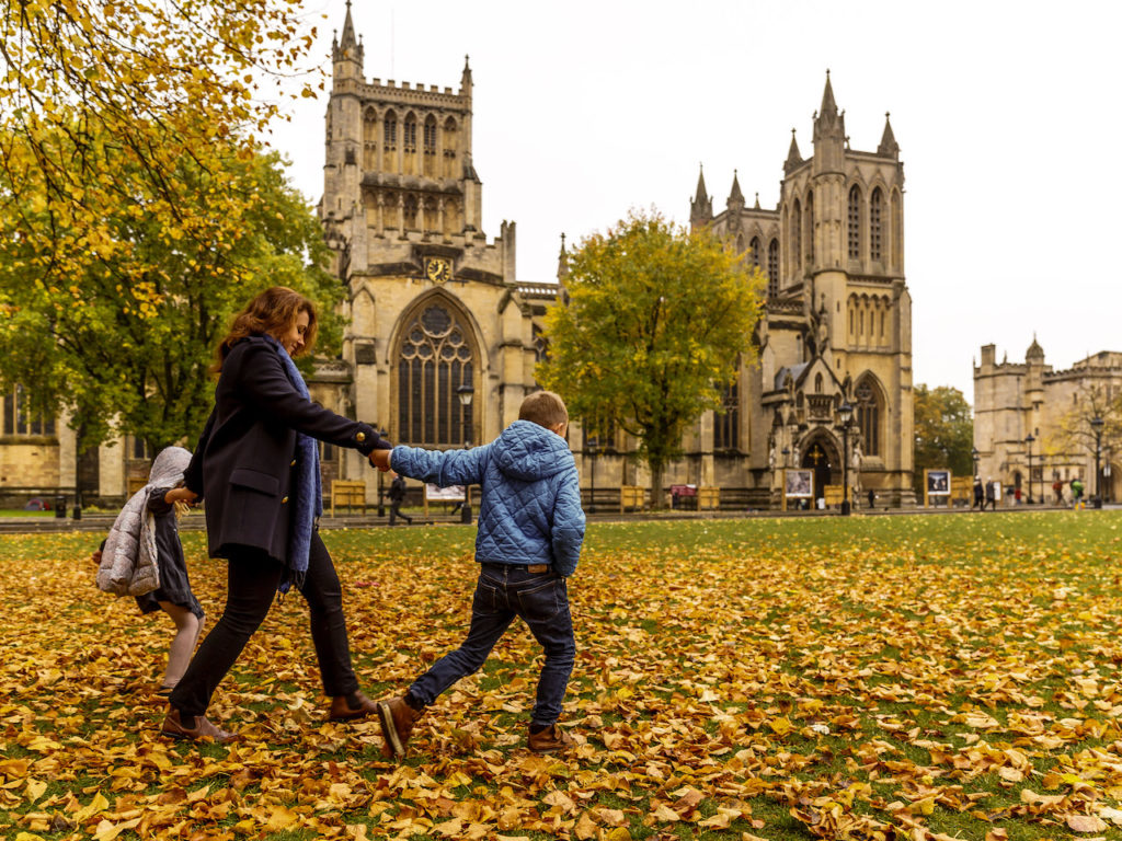 a mother and child in front of a church during autumn on a CityDays Bristol city tour