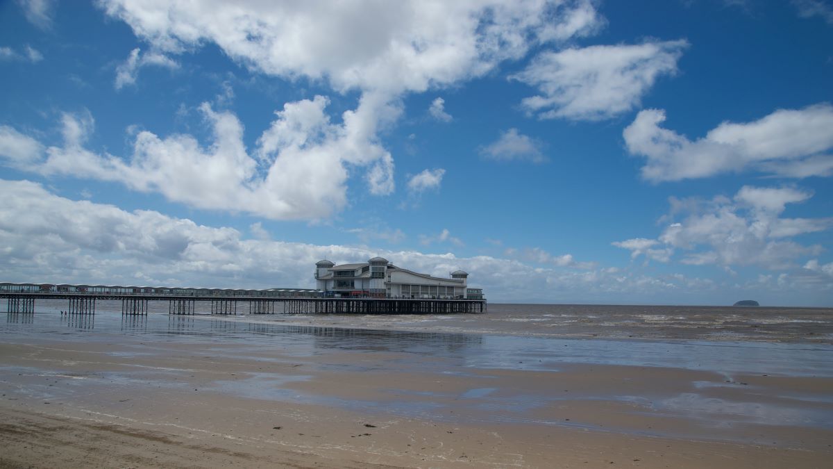 Tide out on the beach at Weston-Super-Mare, with the pier in view, one of the best day trips from Bristol