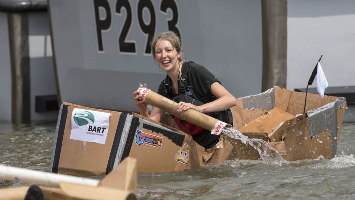 A woman paddling a boat during the cardboard boat race for Bristol Harbour Festival