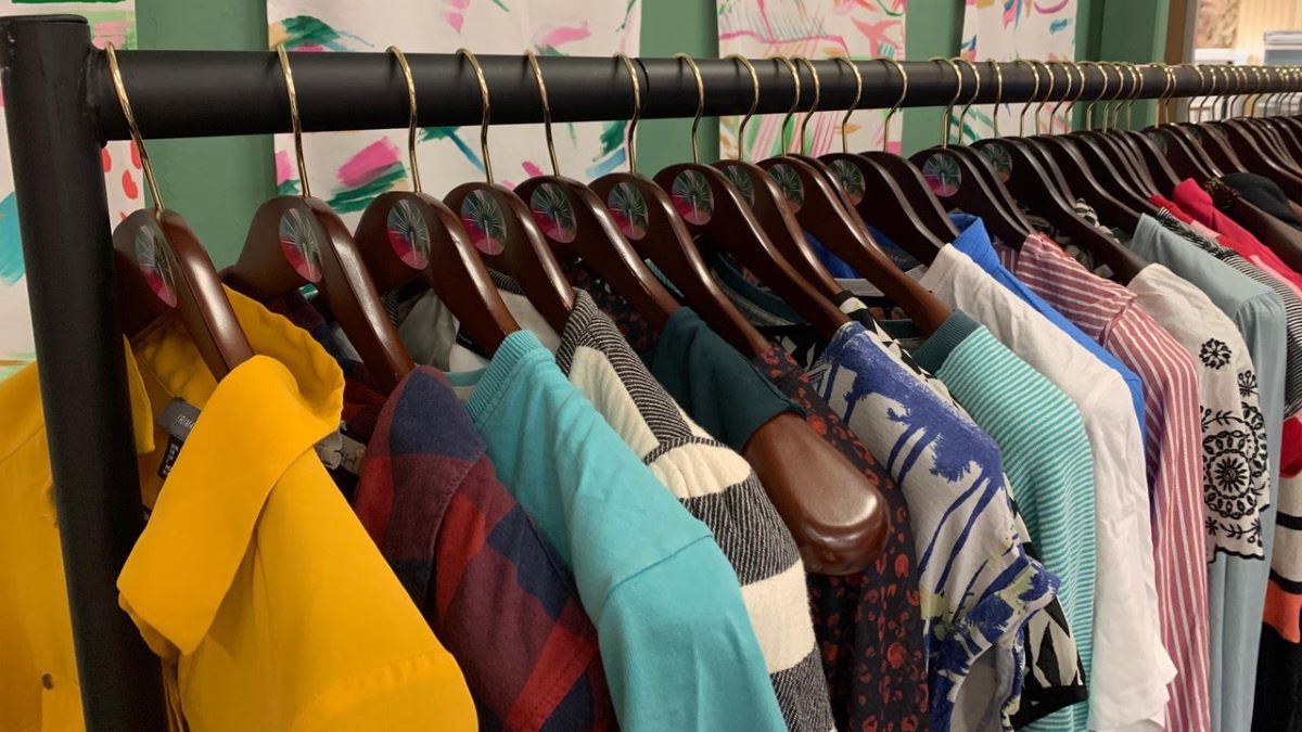 a rail of clothes hanging at Sparks and its sustainable fashion department