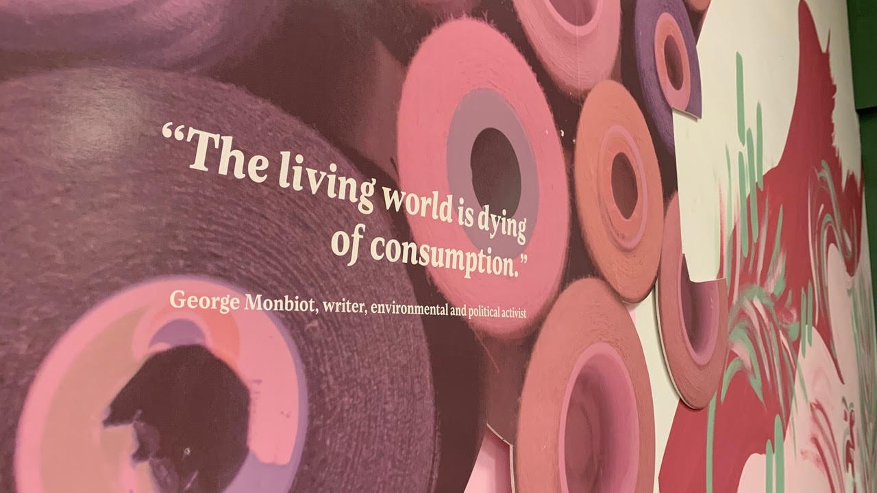 A wall at spark, witha quote from George Monbiot reading: The living world is dying from consumption