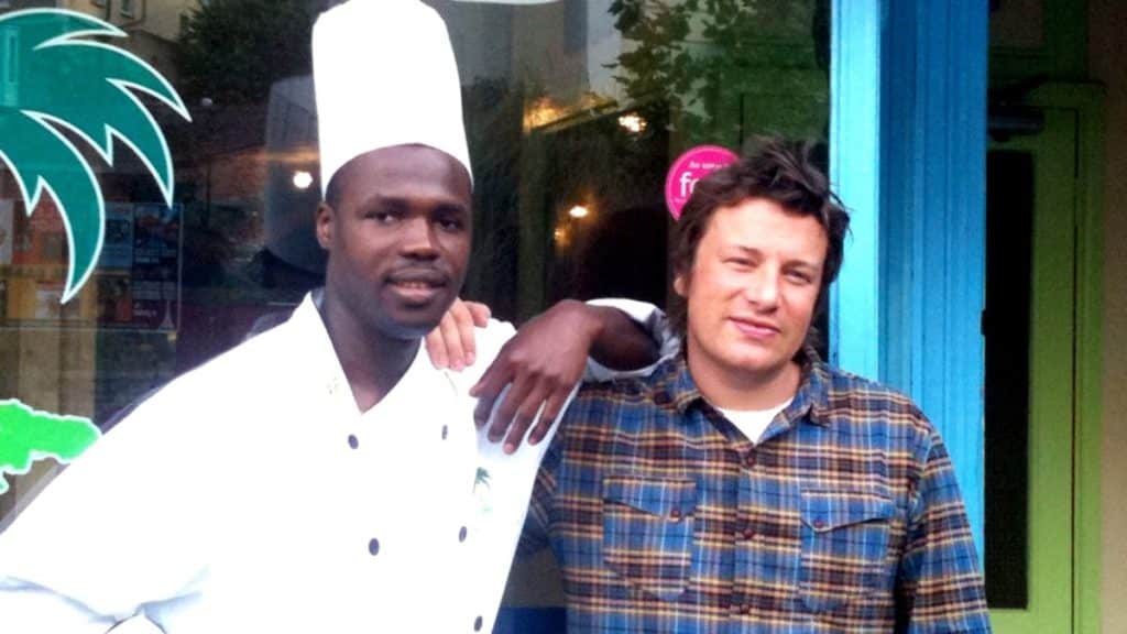 Chef Neufville and Jamie Oliver stood outside of Rice & Things