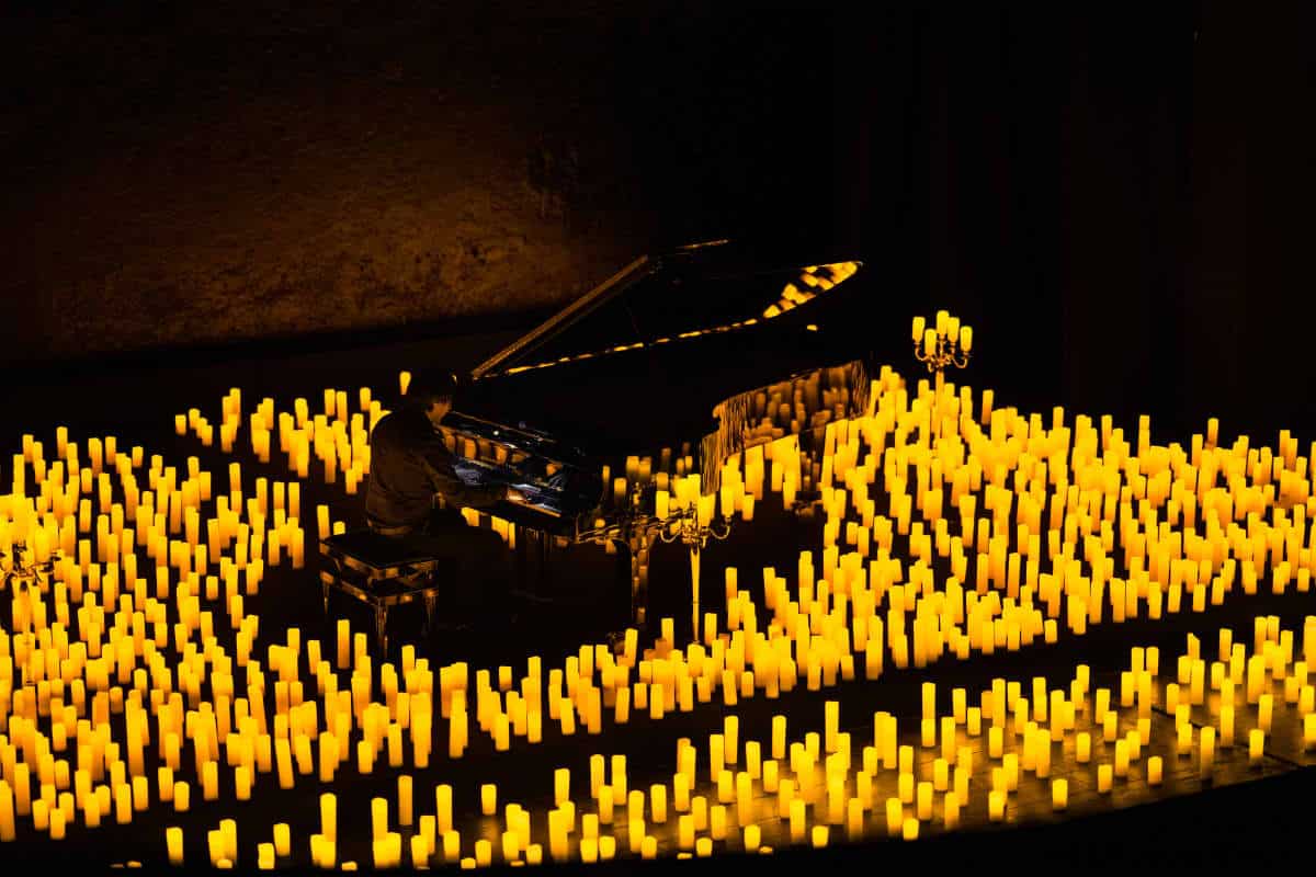 A pianist performing by candlelight
