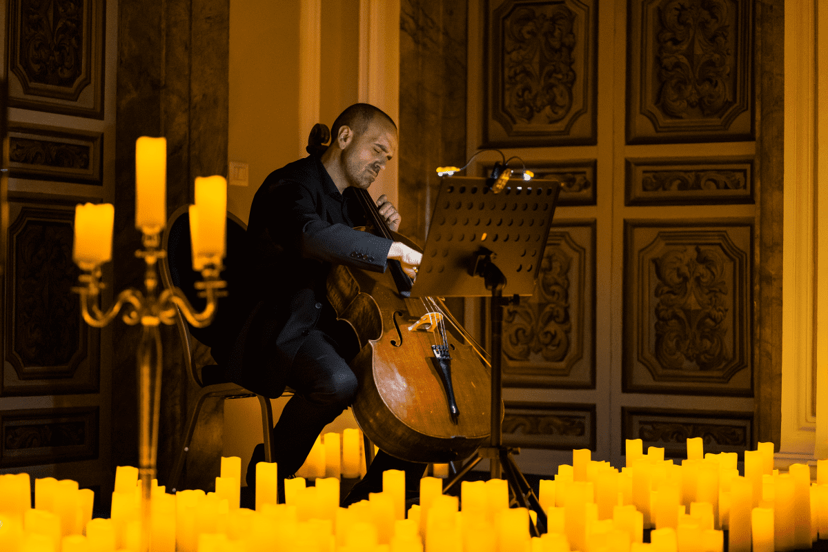 A cello player performing by candlelight